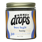 Close-up of Eat Honey Drops Bee Legit packaging featuring a jar of honey with a bee-themed label and natural honey inside.
