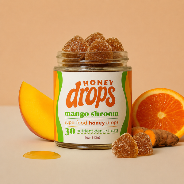 Eat Honey Drops Mango Shroom confection featuring bright mango and mushroom-shaped candies in colorful packaging.