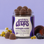 Dark purple Midnight Reishi supplement bottle from Eat Honey Drops with a close-up view of the label.